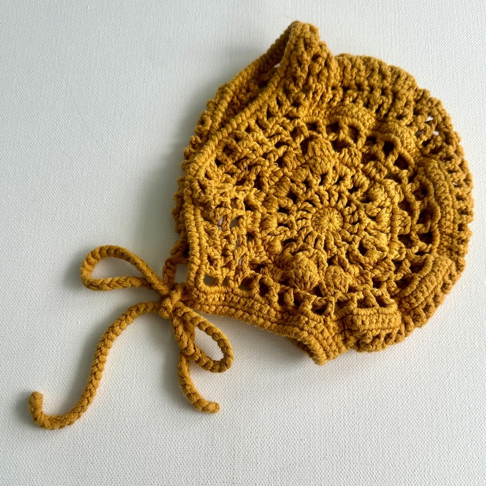 Ponponia girl’s Handmade Crochet Bonnet in Mustard Yellow.